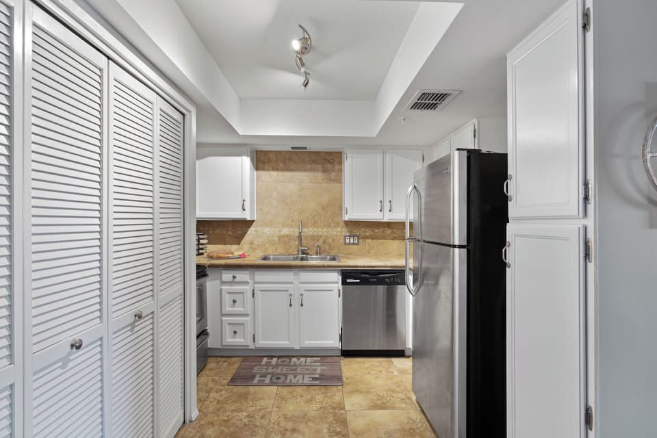 Behind the bifold doors is a full size laundry washer and dryer. 