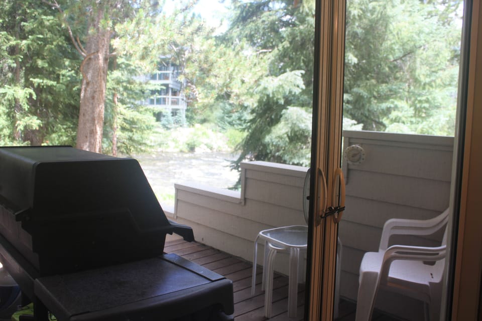 BBQ grill and seating area on the patio overlooking the creek. 