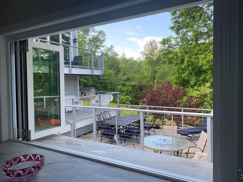 These windows in the kitchen open out onto the outdoor bar and deck