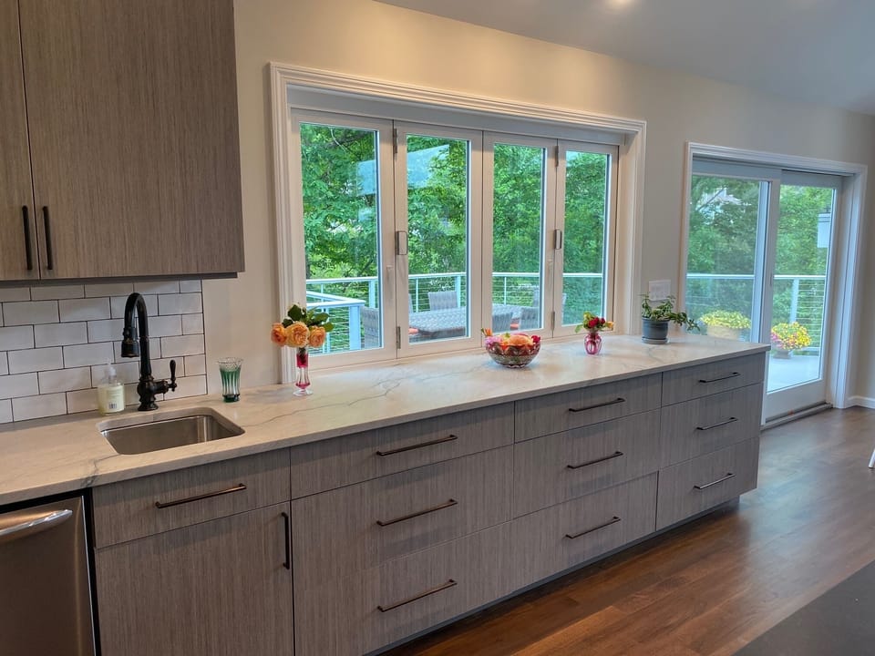 These windows in the kitchen open out onto the outdoor bar and deck
