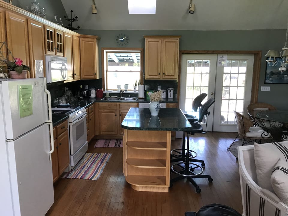 Kitchen with dishwasher, stove, microwave & fridge/freezer. 