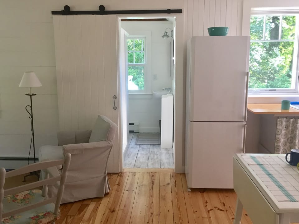 The main bath has a custom built tongue and groove sliding barn door.