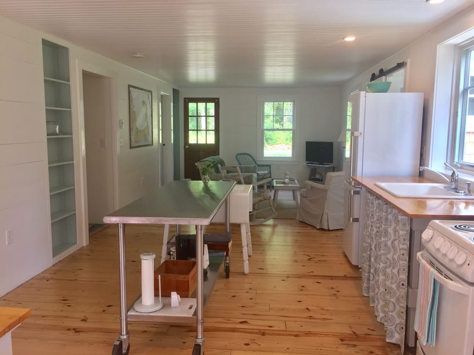 Restored cottage has refinished pine floors, beadboard ceilings & shiplap walls.