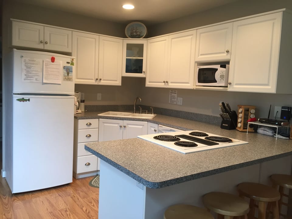 Gourmet Kitchen fully stocked with cooking supplies. Extra seating.