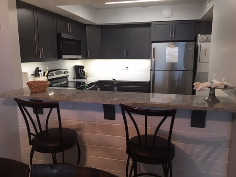 View into kitchen over new ship-lap under-counter.