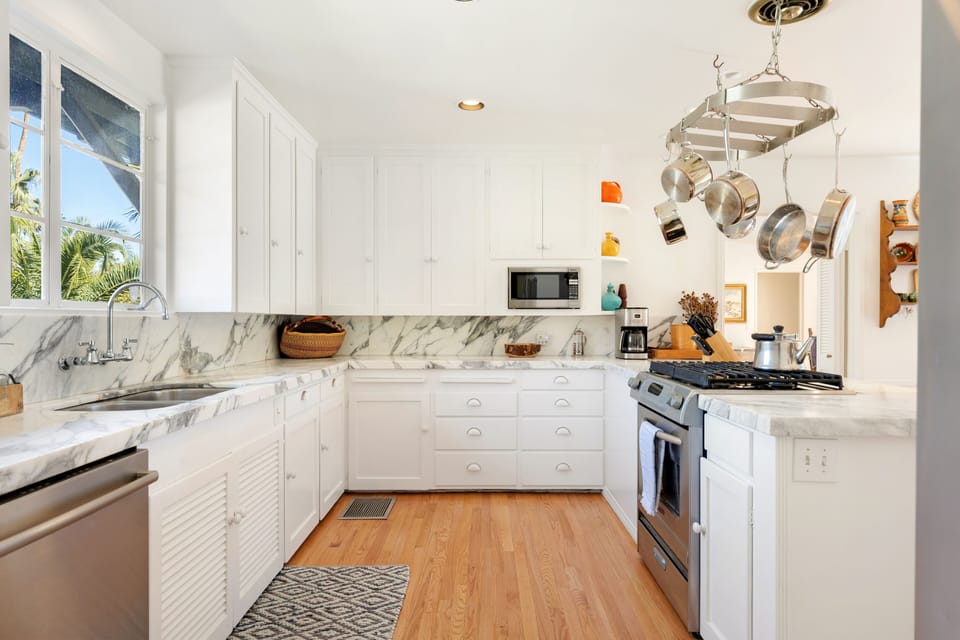 Marble tile counters complement the stainless steel appliances for all cooks