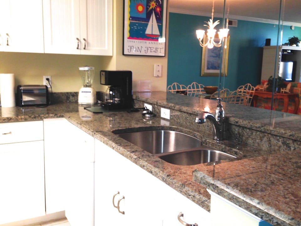 Renovated Kitchen features granite countertops & shaker cabinets.