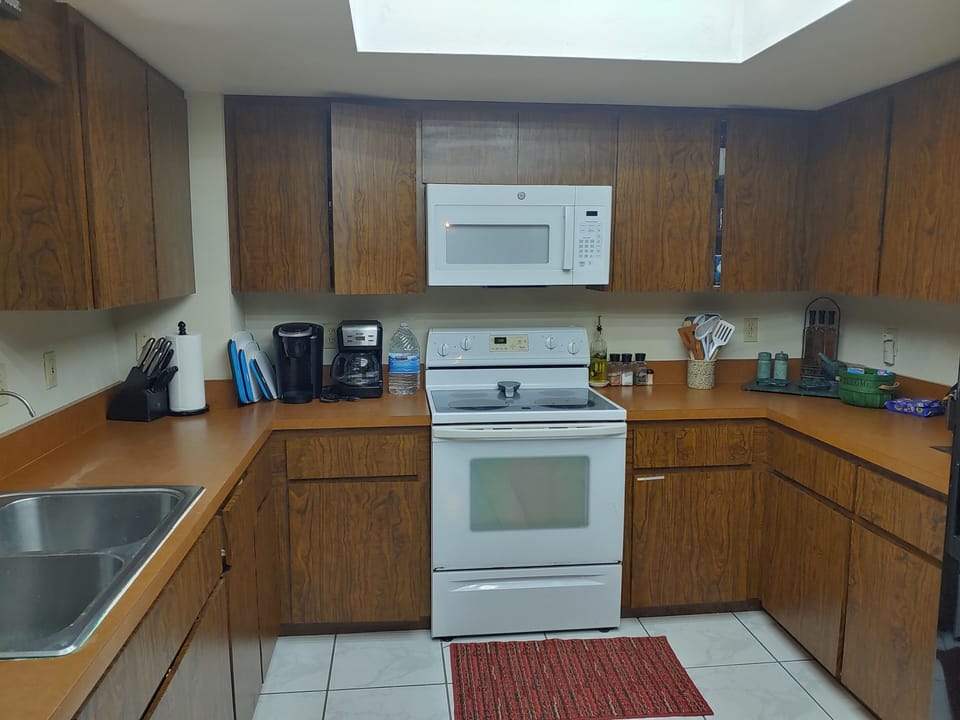 Kitchen with full oven, 4 burner glass top stove, full size microwave