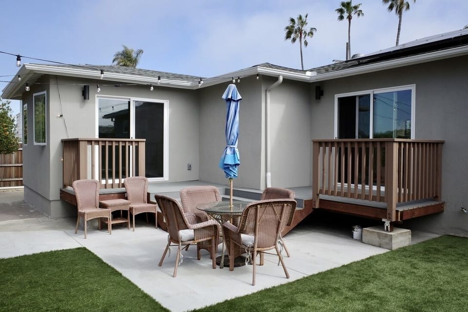 Back yard with patio furniture, cafe lighting, and artificial turf