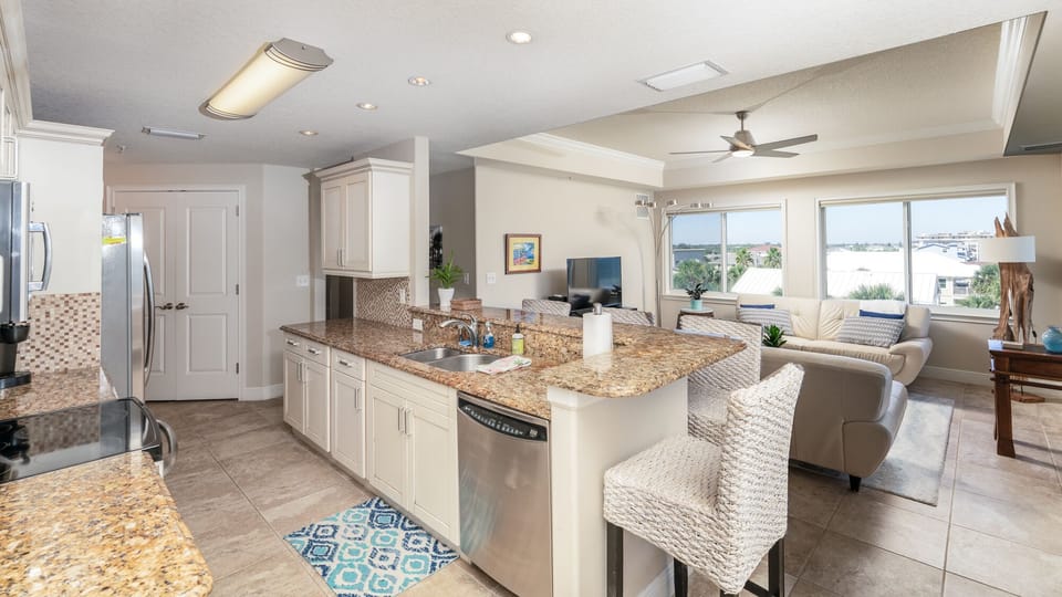 Open kitchen with bar seating for four. 
