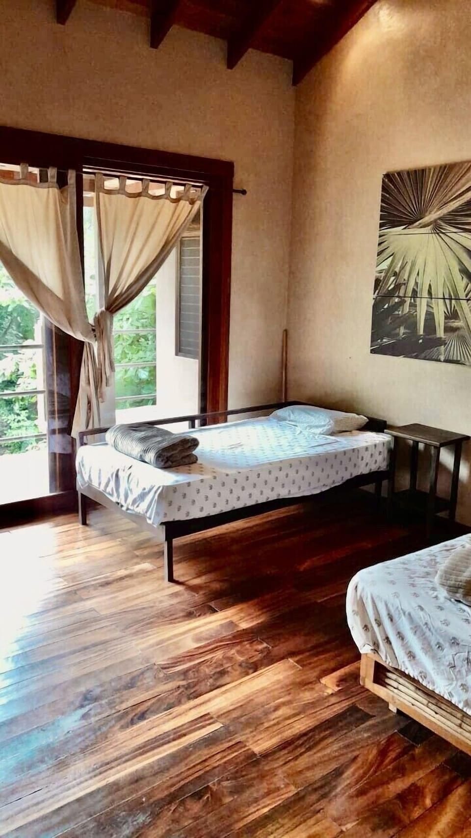 Bedroom for with two twin beds Shared bathroom and balcony access. 