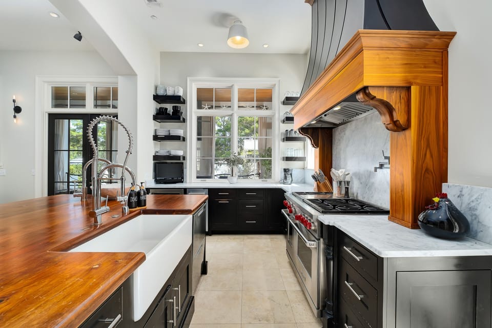 Fully equipped chefs kitchen with 60 inch wolf gas stove and flat top cooking