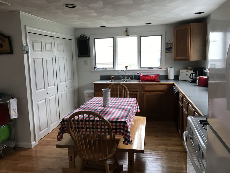 Full sized Washer and Dryer behind folding doors next to the kitchen 