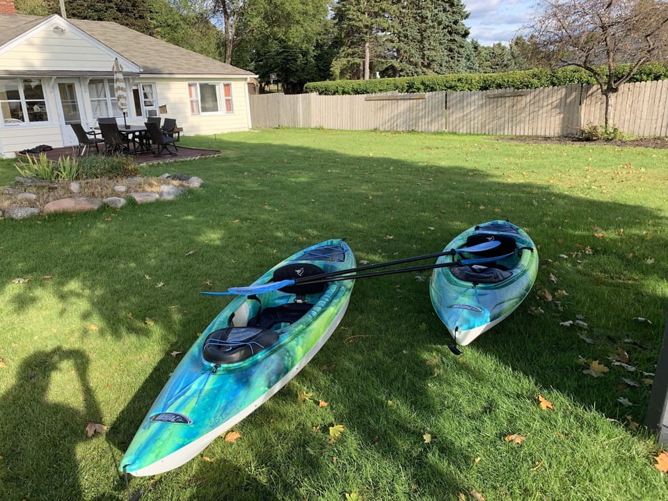 2 new kayaks and bikes to travel around in. Old house in background.