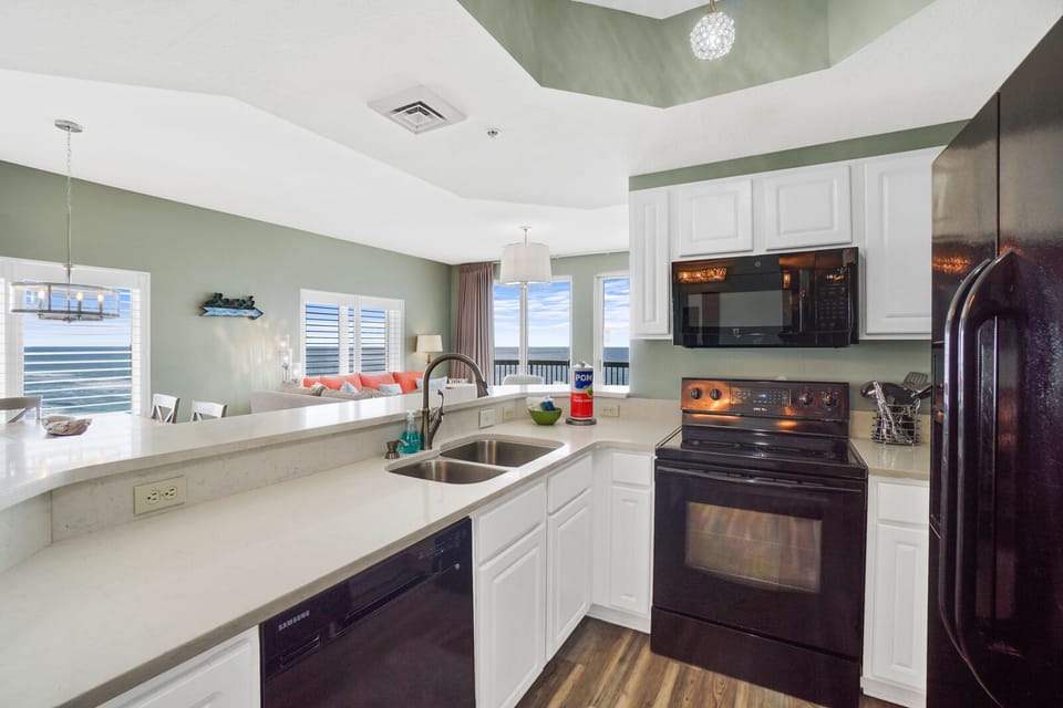 Cook up vacation memories in this fully equipped kitchen with modern appliances and serene ocean views through your windows.