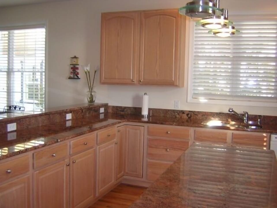 Open and spacious kitchen with all you need.  Barstools make it easy to serve.

