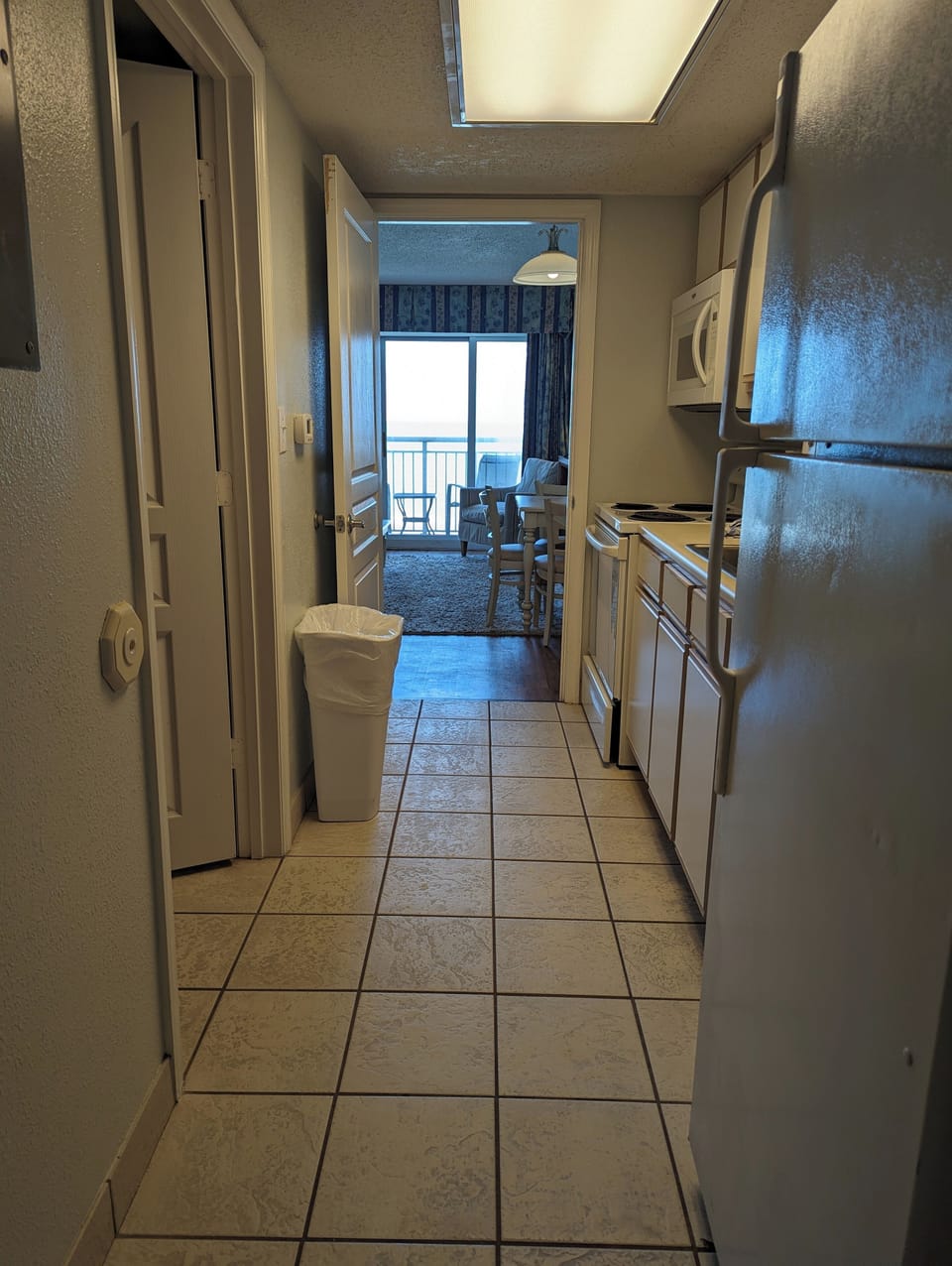 Looking from the kitchen through the living room to the balcony