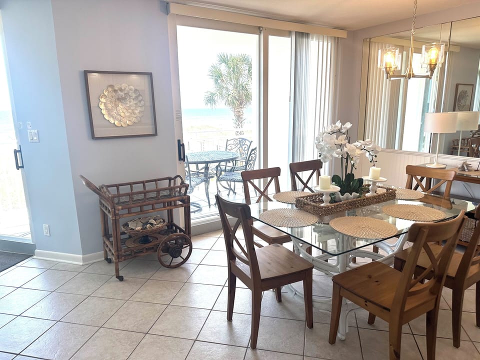 Light filled dining facing gulf and open to kitchen and living areas