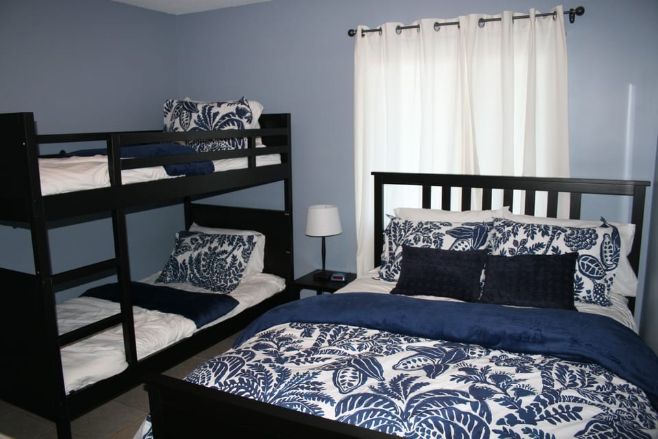 Bright and comfy second bedroom with queen sized bed and two bunk twin beds