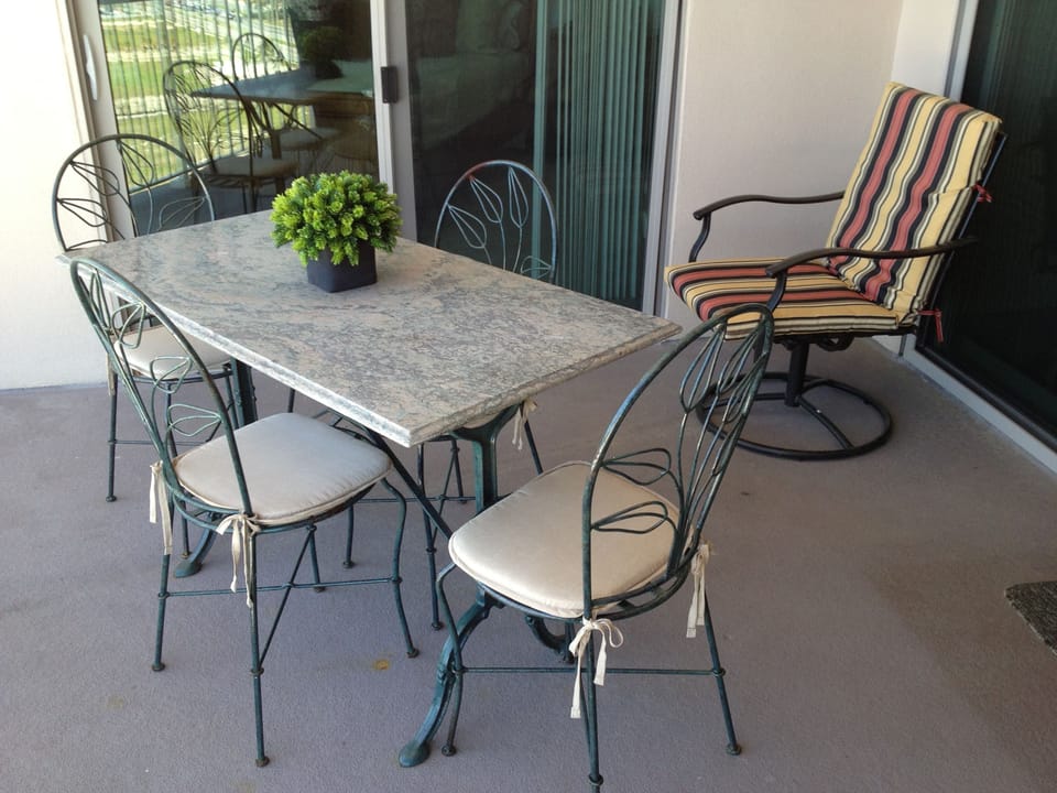 Quaint seating for dining on the balcony & 4 other chairs for simply relaxing. 