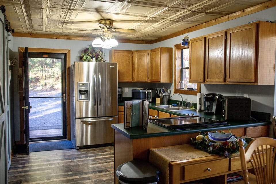 Kitchen with updated appliances and ample cookware. 
