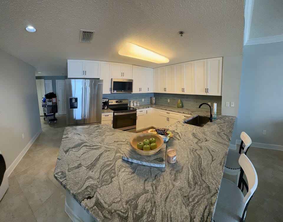 Kitchen w beautiful leathered granite countertops, new cabinets, new appliances