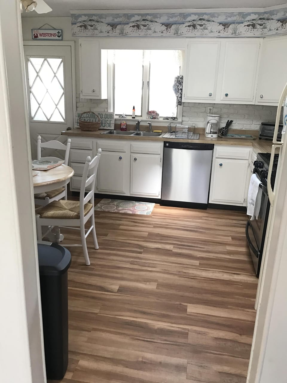 New floor and stainless steel appliances