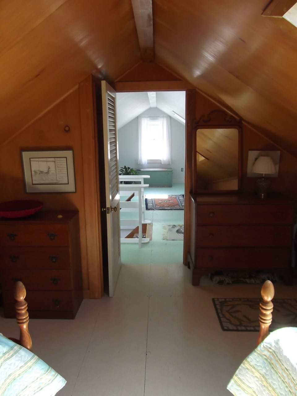 The upstairs bedroom opens into the sunny sitting room...