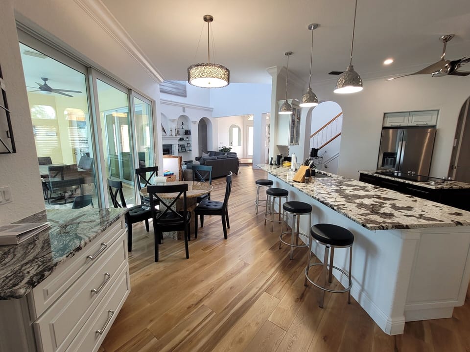 KITCHEN COUNTER, REFREIGERATOR & ISLAND VIEW FROM MEDIA ROOM