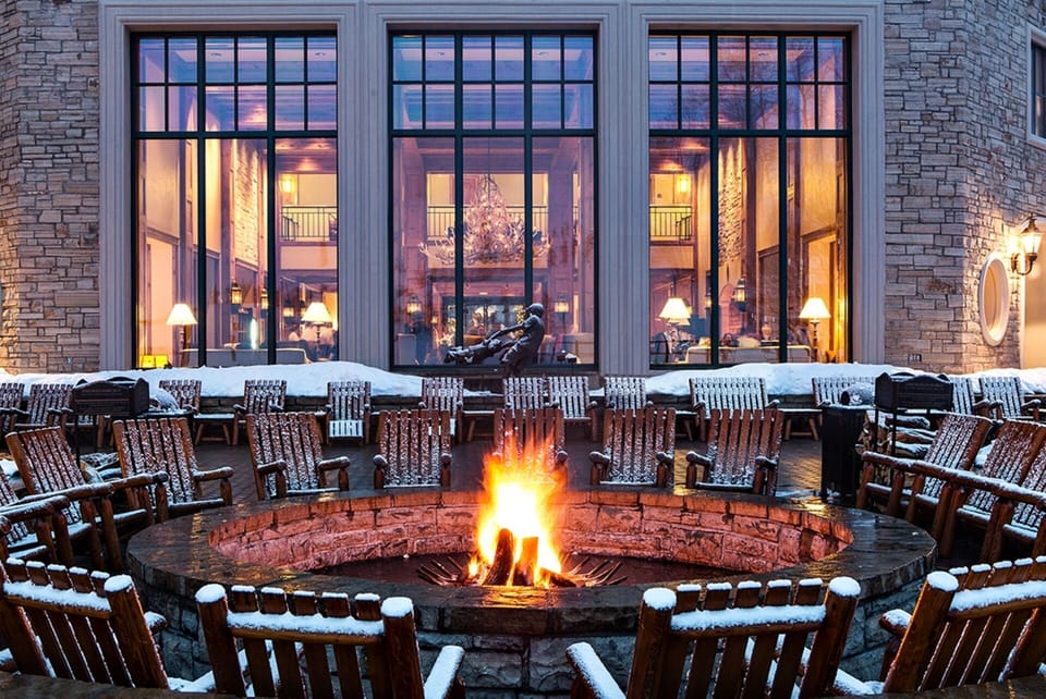 Fire Pit on Park Hyatt Patio with view of Antler Hall at base of slopes
