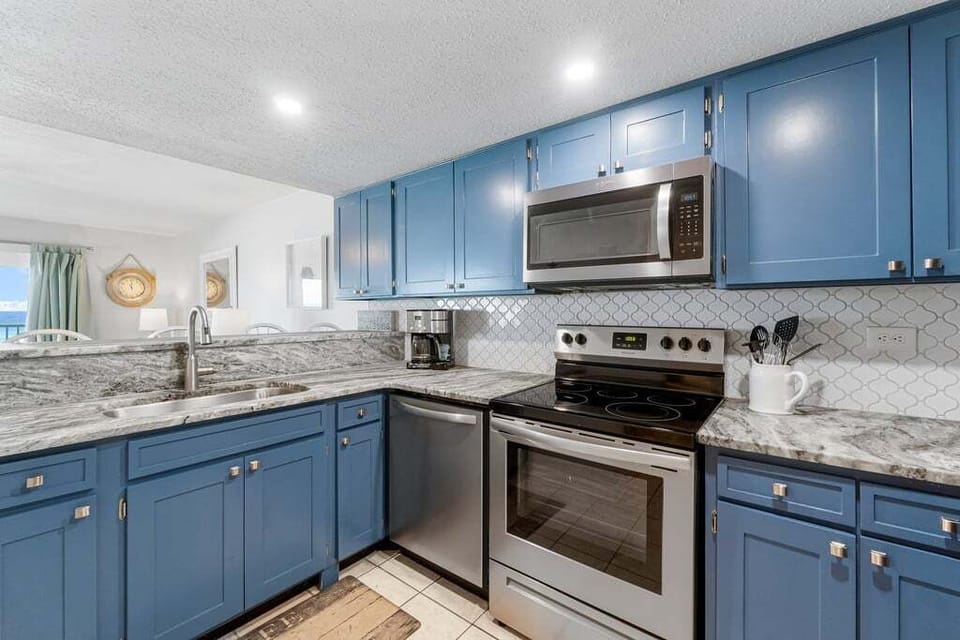Additional small appliances (blender, crock pot) available in cabinets.