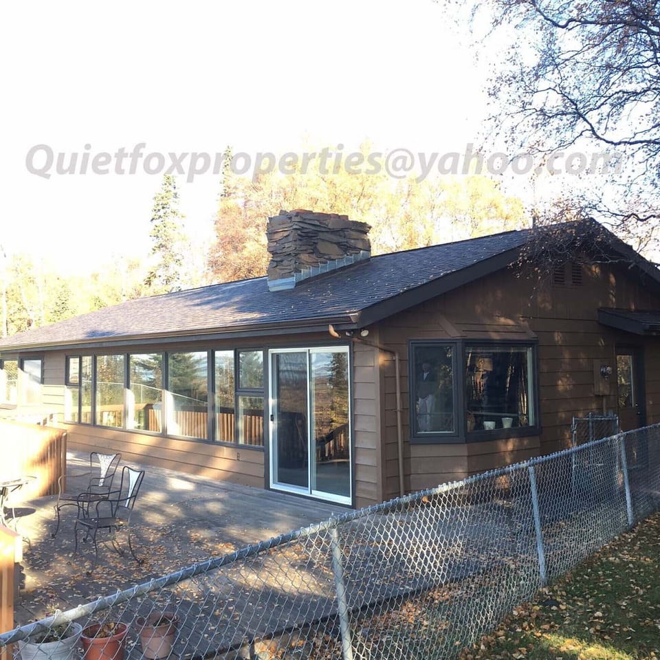Large back deck with two BBQ's and backyard for outdoor parties .