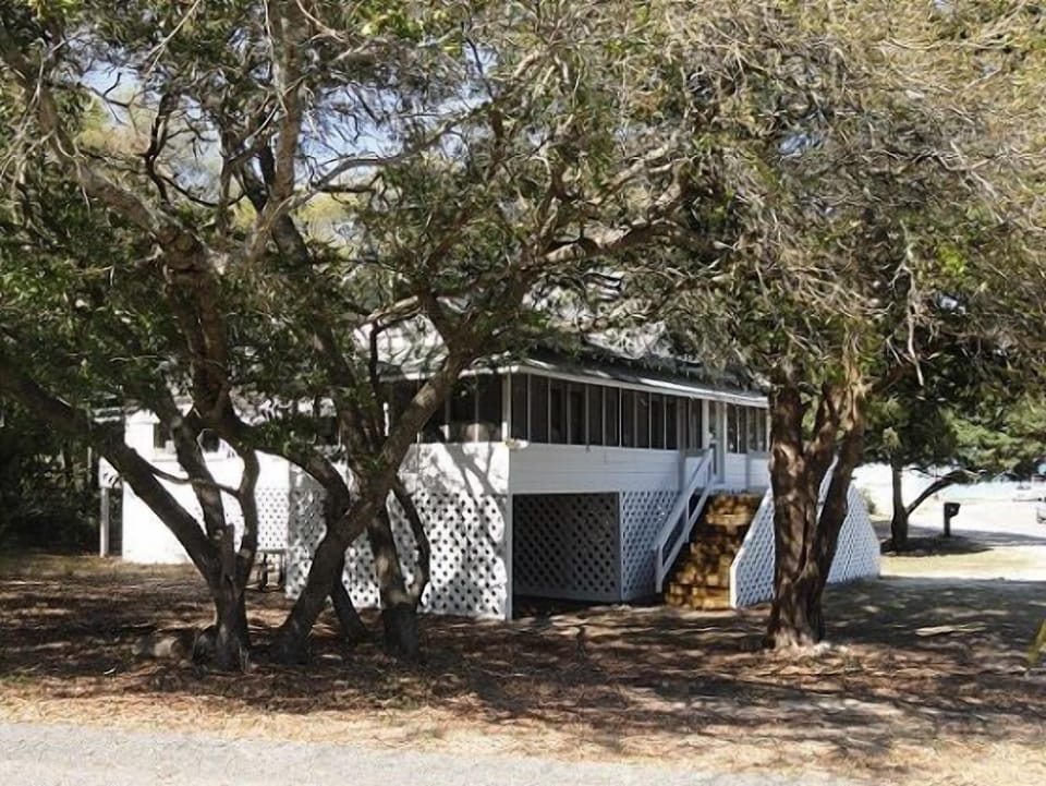Shade from the old oak trees helps keep the porch cool