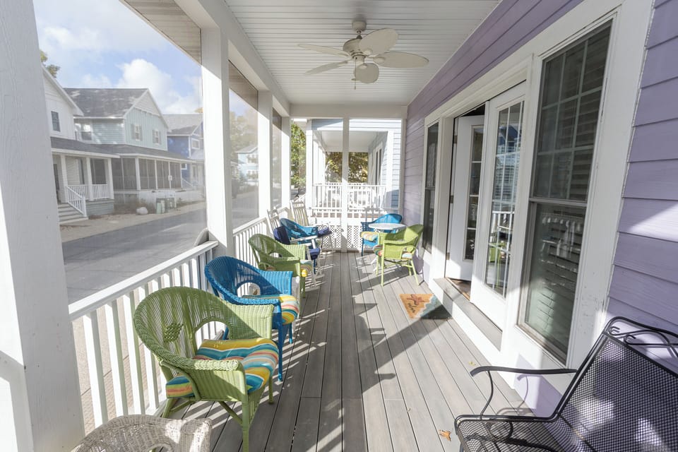 Enclosed front porch with plenty of seating to relax. 