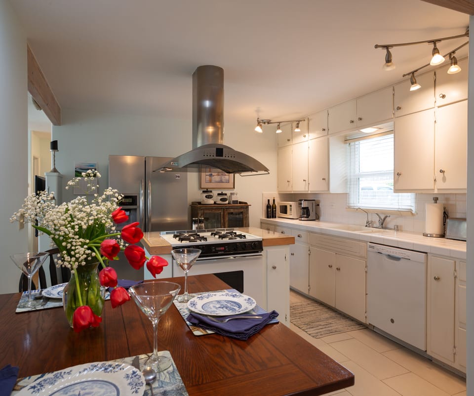 Kitchen dining, newer dishwasher and gas range. 2 door refrigerator on far wall.