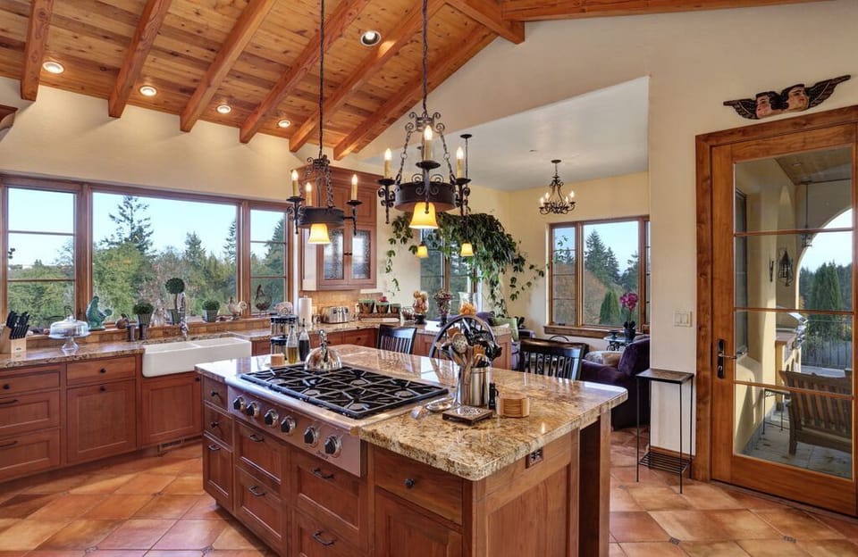 Chef's kitchen with sunroom & French door leading to large slate covered patio.