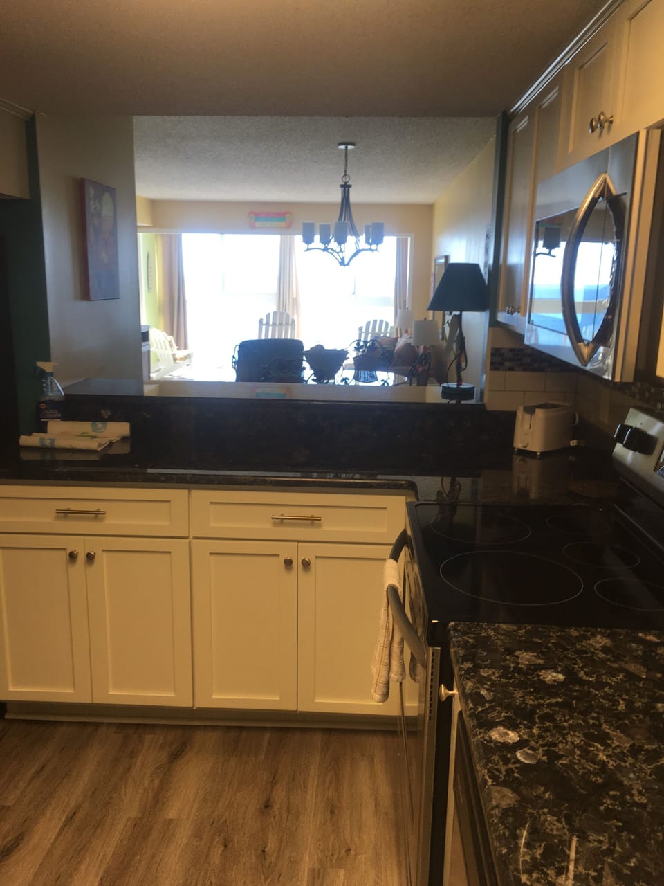 View from kitchen through living area with windows overlooking the beach!