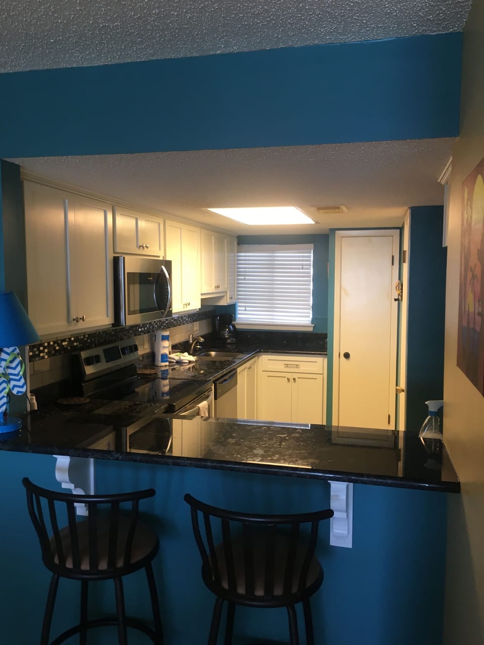 Bar seating plus dining table accommodates 6.