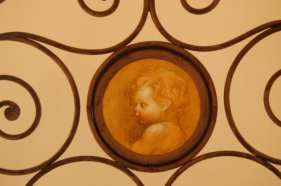 Hand painted cherub on kids bed frame