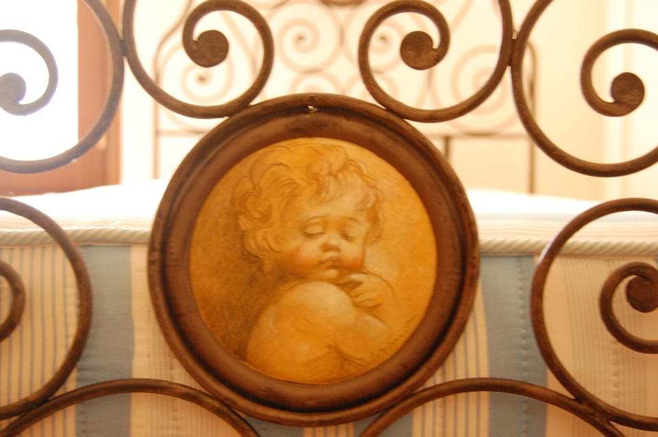 Hand painted cherub on kids bed frame
