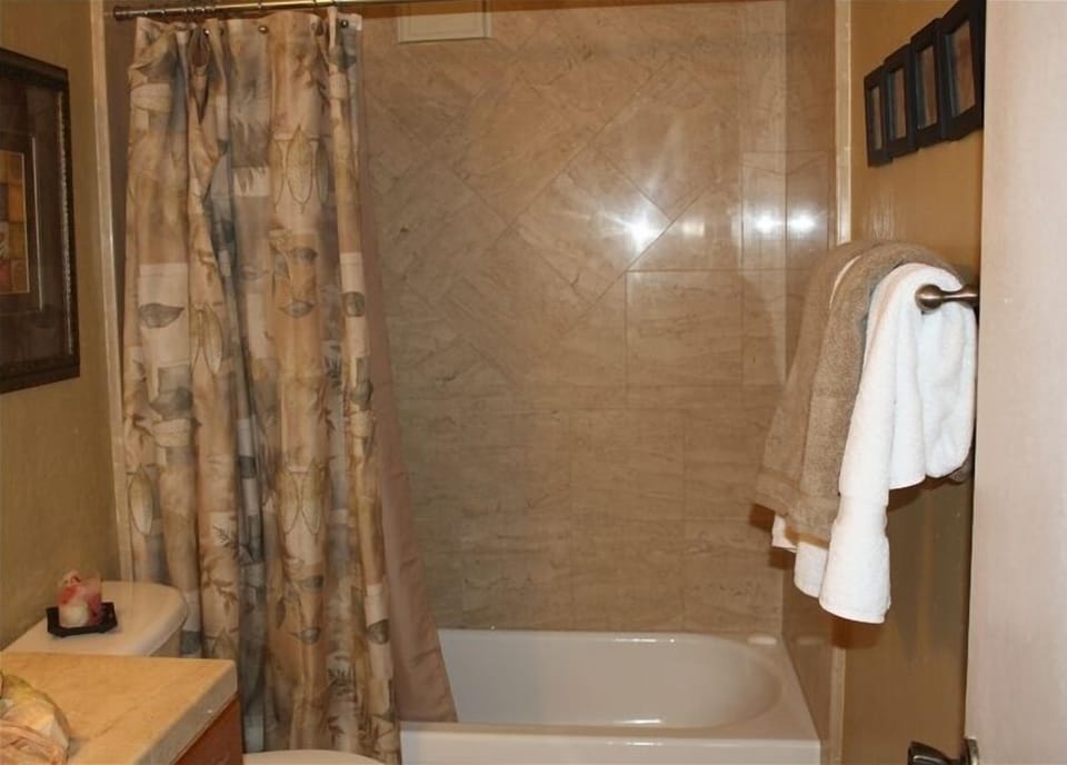 Remodeled bathroom with marble bath surround