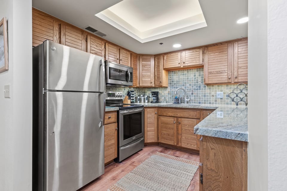 Kitchen with SS appliances, granite, slate backsplash
