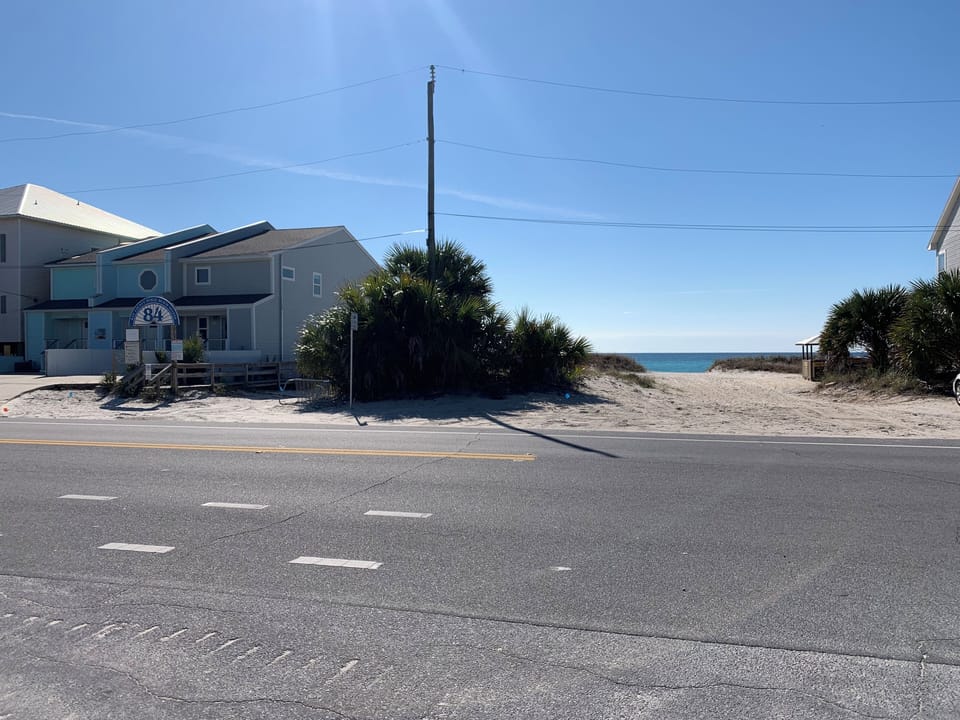 Beach entrance 1 short block away with parking for golfcart and wooden walkway.
