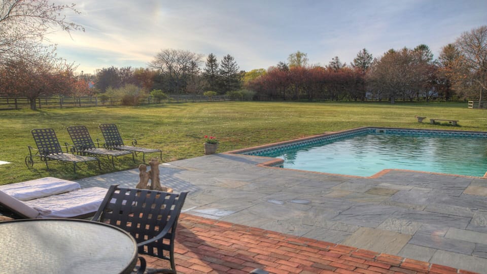 Bluestone to pool and terrace with BBQ and table for outside dining.