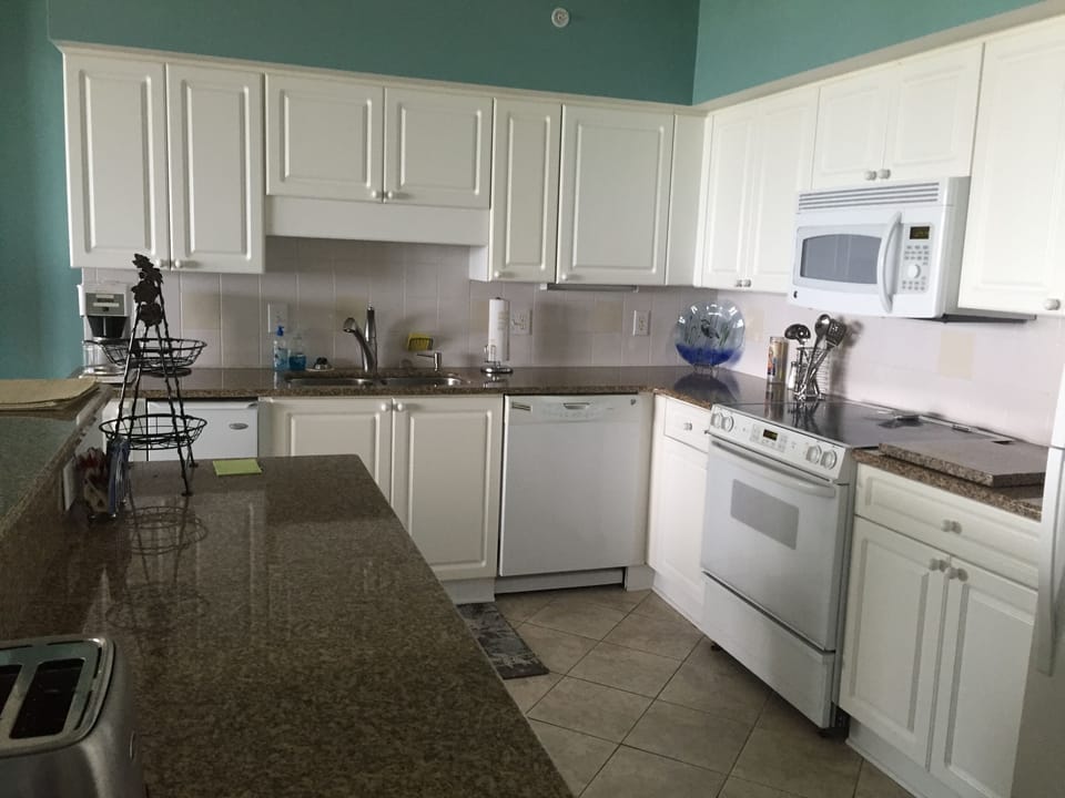 Kitchen area with all appliances and granite countertops.