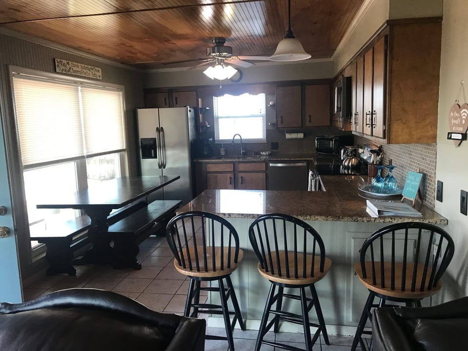 Lower level kitchen area with updated appliances and granite countertops