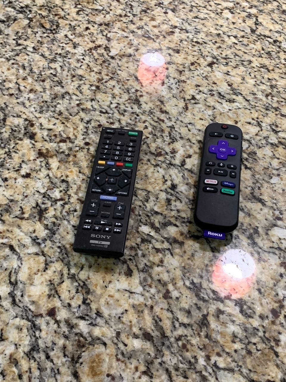 Remote controls on granite counter in kitchen for Flat Smart TV