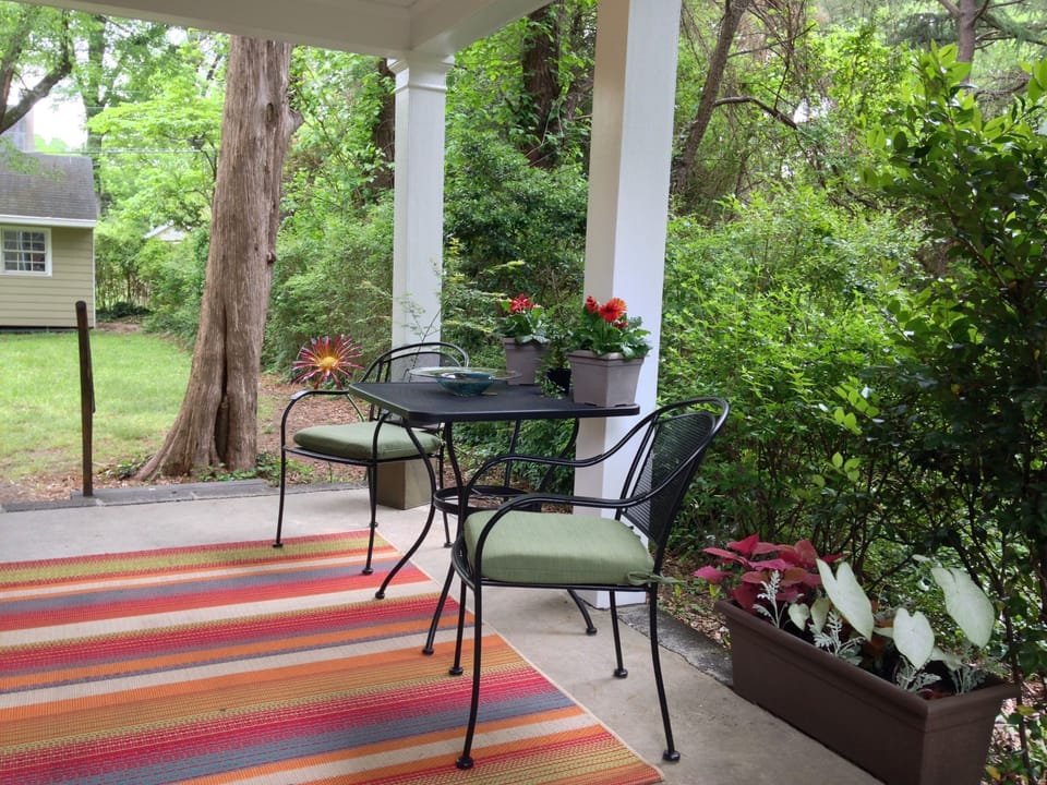 Covered side porch with seating area.