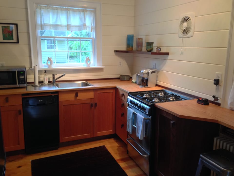 Kitchen with gas stove, dish washer and microwave.