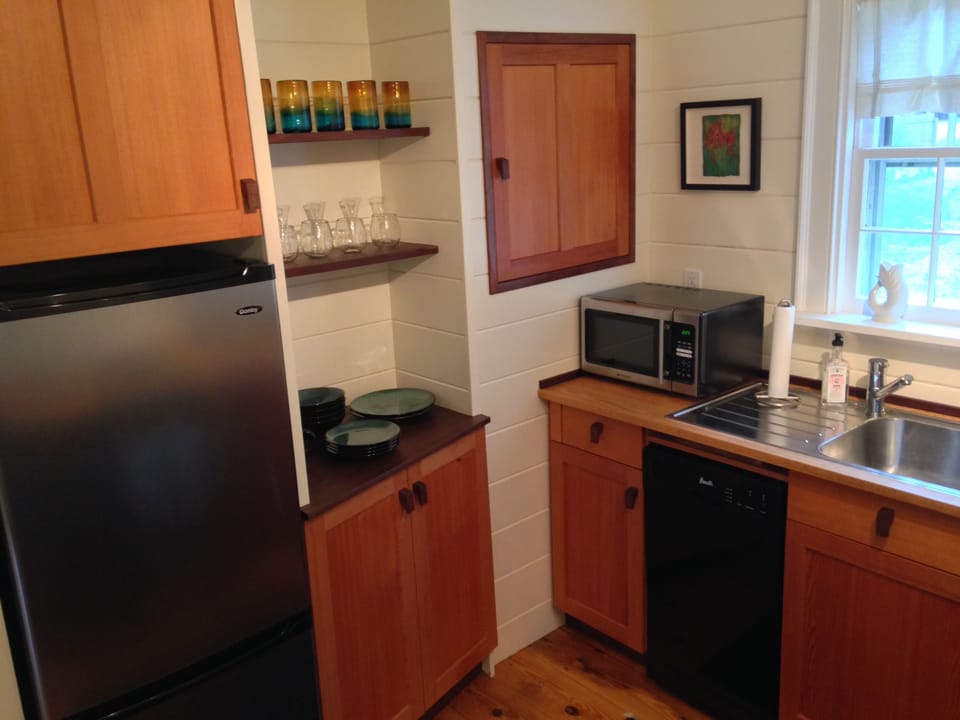 Kitchen with dishes and fridge.